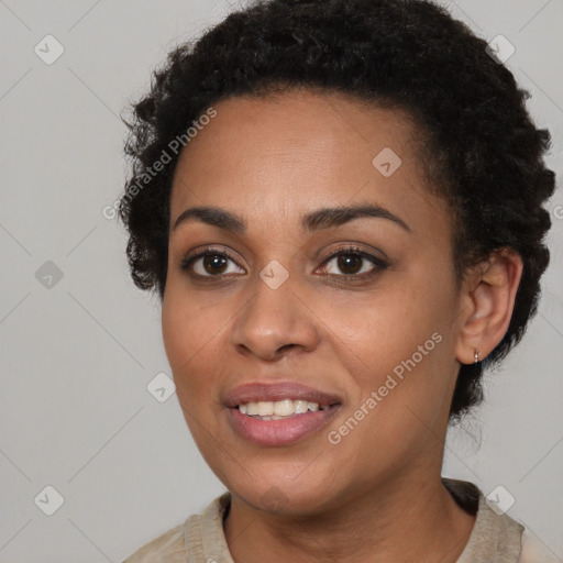 Joyful black young-adult female with short  brown hair and brown eyes