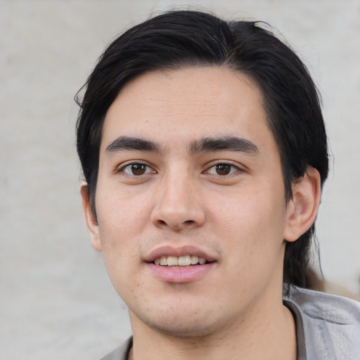 Joyful white young-adult male with short  black hair and brown eyes