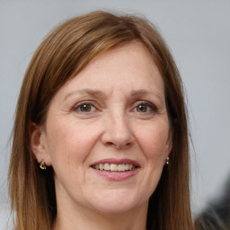 Joyful white adult female with long  brown hair and grey eyes