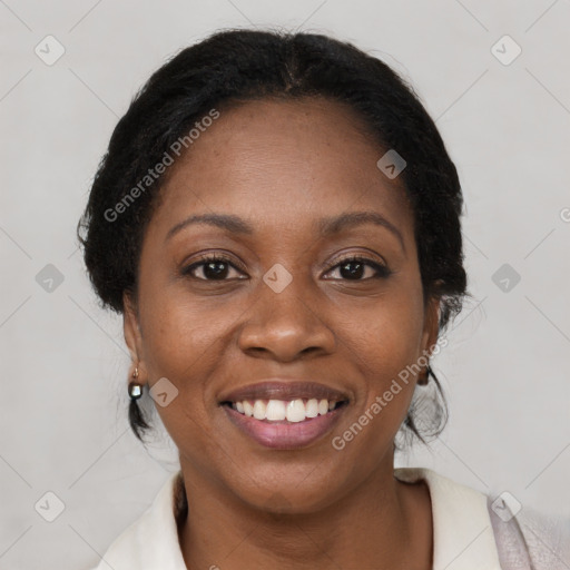 Joyful black adult female with medium  brown hair and brown eyes