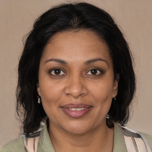Joyful black adult female with medium  brown hair and brown eyes