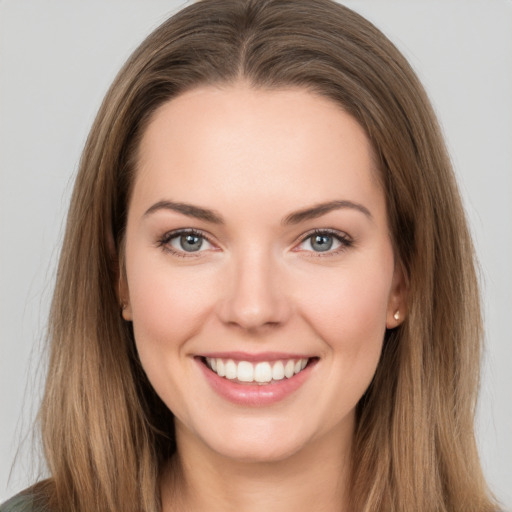 Joyful white young-adult female with long  brown hair and grey eyes