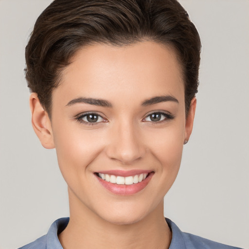 Joyful white young-adult female with short  brown hair and brown eyes