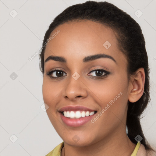 Joyful latino young-adult female with long  brown hair and brown eyes