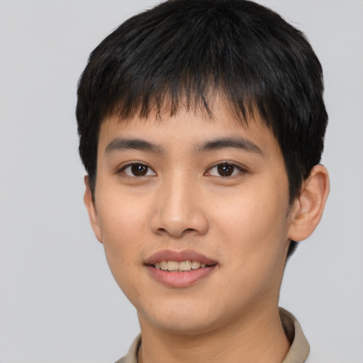 Joyful asian young-adult male with short  black hair and brown eyes