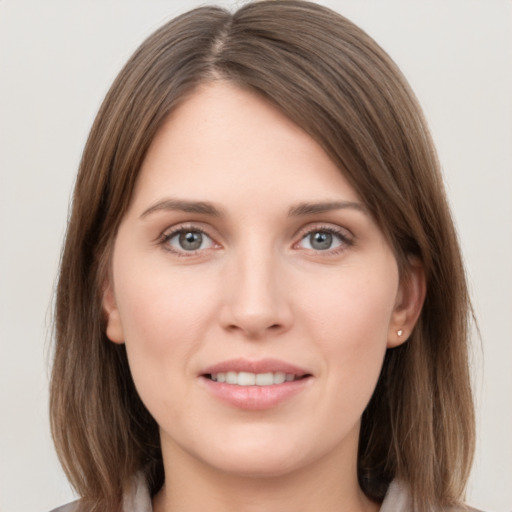 Joyful white young-adult female with medium  brown hair and grey eyes