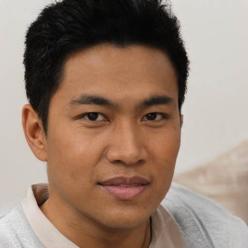 Joyful asian young-adult male with short  brown hair and brown eyes