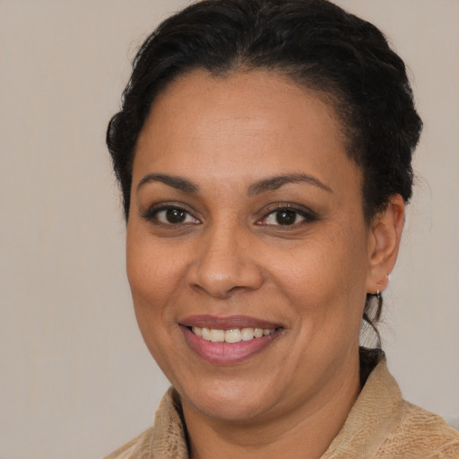 Joyful latino adult female with medium  brown hair and brown eyes