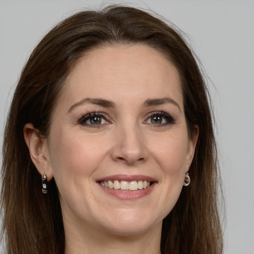 Joyful white young-adult female with long  brown hair and grey eyes