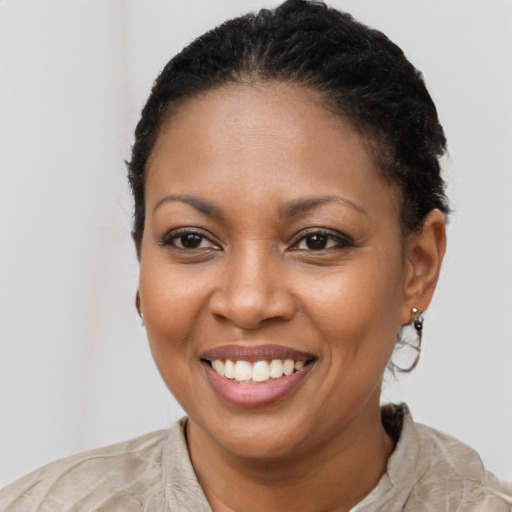 Joyful black young-adult female with short  brown hair and brown eyes