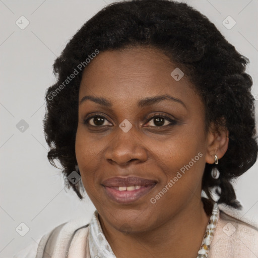 Joyful black adult female with medium  brown hair and brown eyes