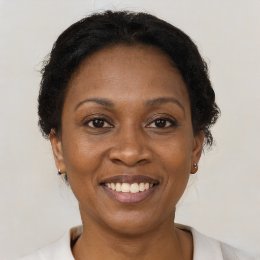 Joyful black adult female with short  brown hair and brown eyes