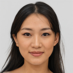 Joyful asian young-adult female with long  brown hair and brown eyes