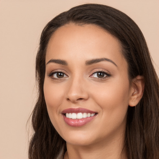 Joyful white young-adult female with long  brown hair and brown eyes