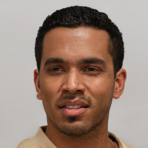 Joyful latino young-adult male with short  black hair and brown eyes