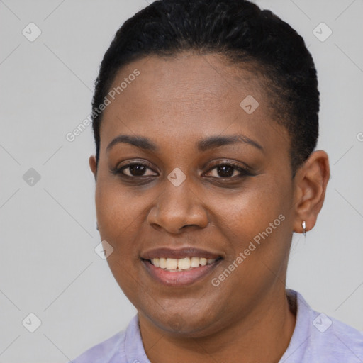 Joyful black young-adult female with short  black hair and brown eyes