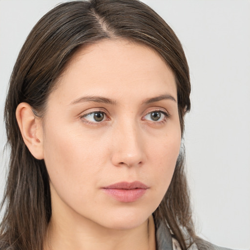 Neutral white young-adult female with long  brown hair and brown eyes