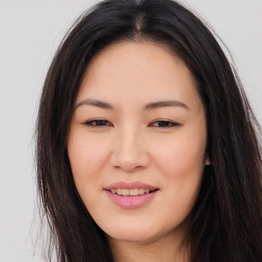 Joyful asian young-adult female with long  brown hair and brown eyes