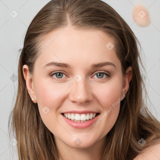 Joyful white young-adult female with long  brown hair and blue eyes