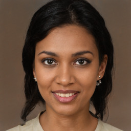 Joyful black young-adult female with medium  brown hair and brown eyes