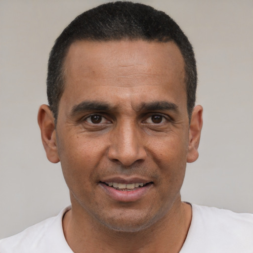 Joyful latino adult male with short  black hair and brown eyes