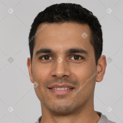 Joyful latino young-adult male with short  black hair and brown eyes