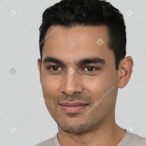 Joyful white young-adult male with short  black hair and brown eyes