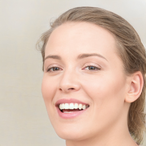 Joyful white young-adult female with long  brown hair and blue eyes