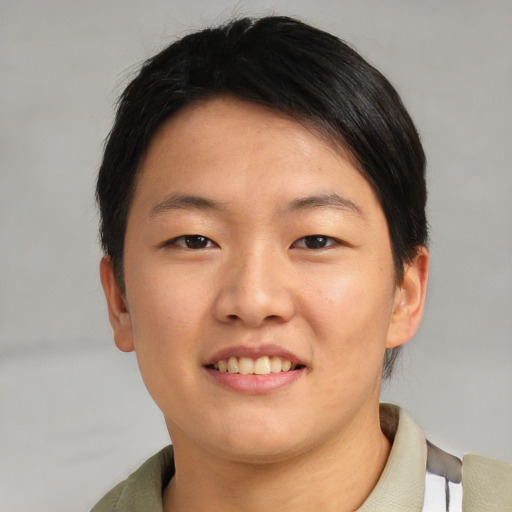 Joyful asian young-adult female with short  brown hair and brown eyes