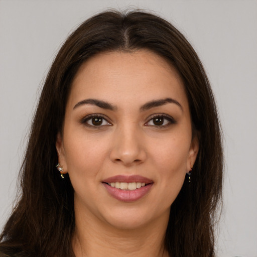 Joyful white young-adult female with long  brown hair and brown eyes