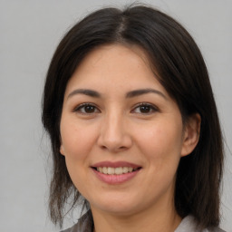 Joyful asian adult female with medium  brown hair and brown eyes