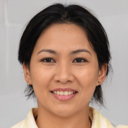 Joyful asian young-adult female with medium  brown hair and brown eyes