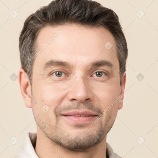 Joyful white adult male with short  brown hair and brown eyes