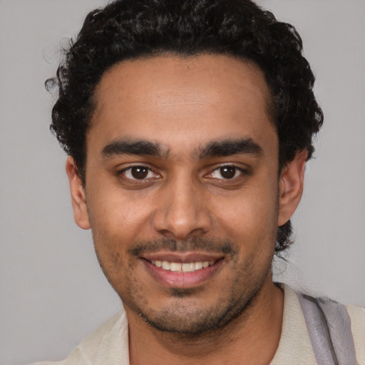Joyful latino young-adult male with short  black hair and brown eyes