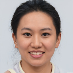 Joyful asian young-adult female with short  brown hair and brown eyes