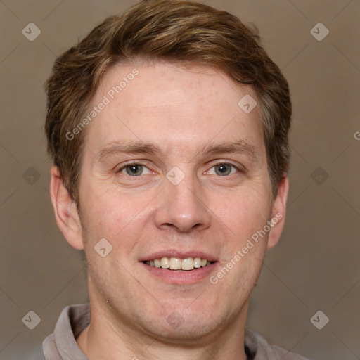 Joyful white adult male with short  brown hair and grey eyes