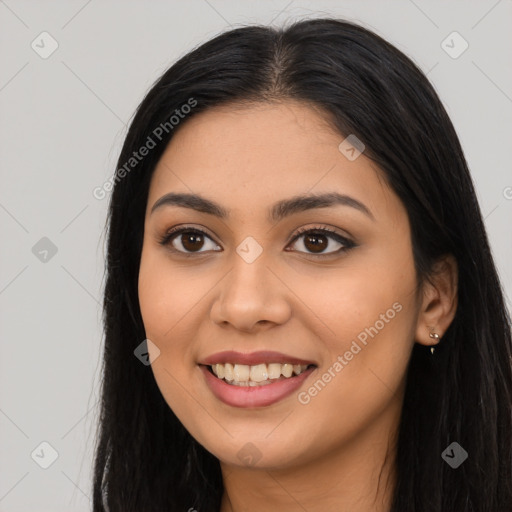 Joyful latino young-adult female with long  black hair and brown eyes