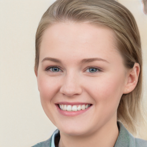 Joyful white young-adult female with medium  brown hair and blue eyes