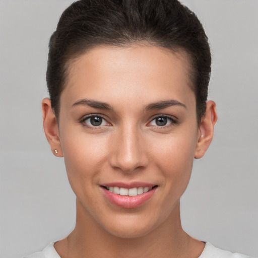 Joyful white young-adult female with short  brown hair and brown eyes