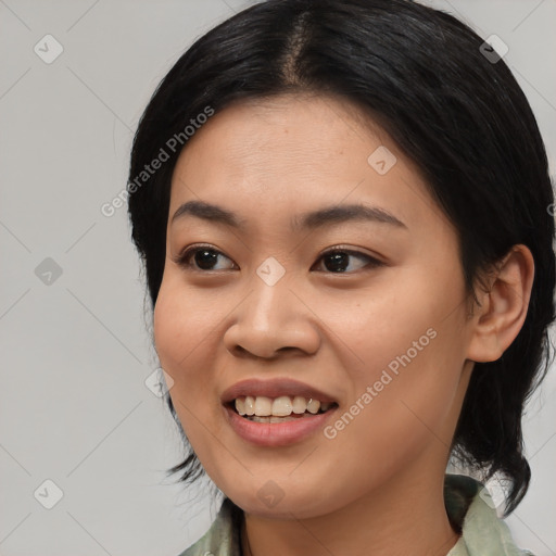 Joyful asian young-adult female with medium  black hair and brown eyes