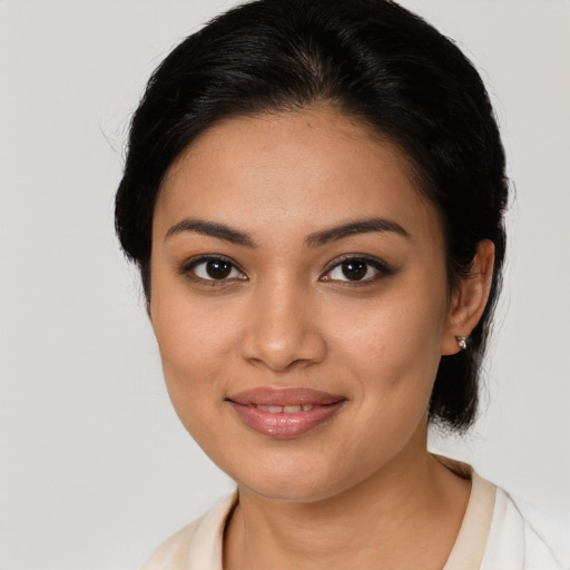 Joyful latino young-adult female with medium  brown hair and brown eyes
