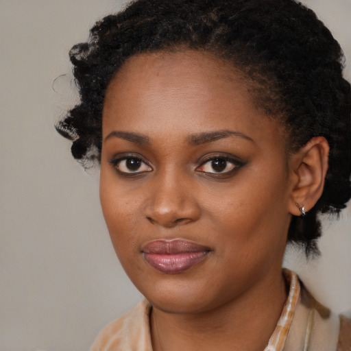 Joyful black young-adult female with medium  black hair and brown eyes