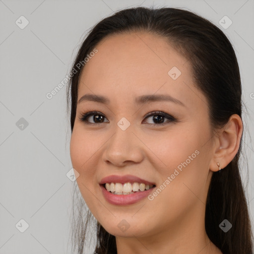 Joyful asian young-adult female with long  brown hair and brown eyes