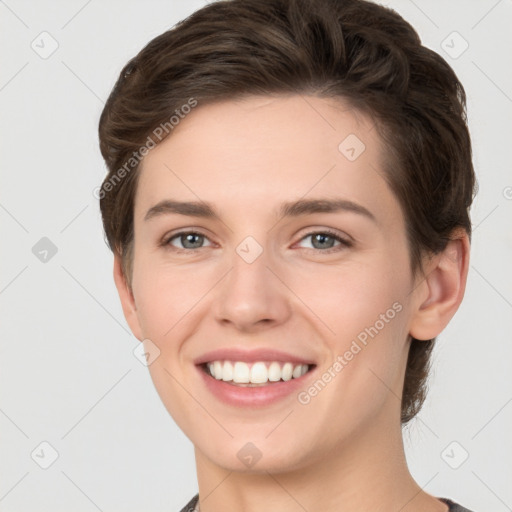 Joyful white young-adult female with short  brown hair and grey eyes