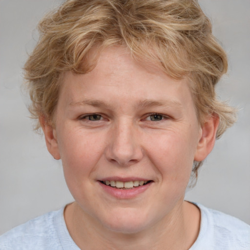 Joyful white young-adult female with short  brown hair and blue eyes