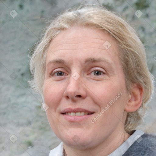 Joyful white adult female with medium  brown hair and blue eyes