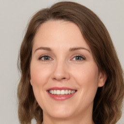 Joyful white young-adult female with medium  brown hair and green eyes