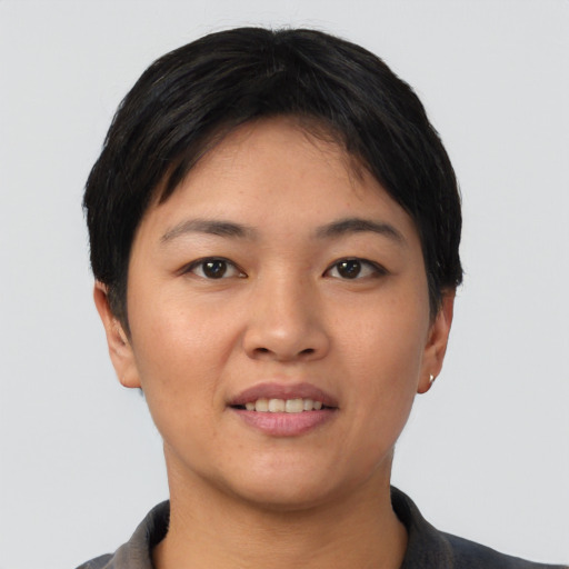 Joyful asian young-adult female with short  black hair and brown eyes