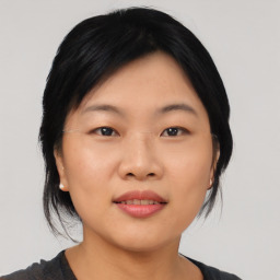 Joyful asian young-adult female with medium  black hair and brown eyes