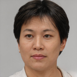 Joyful asian adult female with short  brown hair and brown eyes